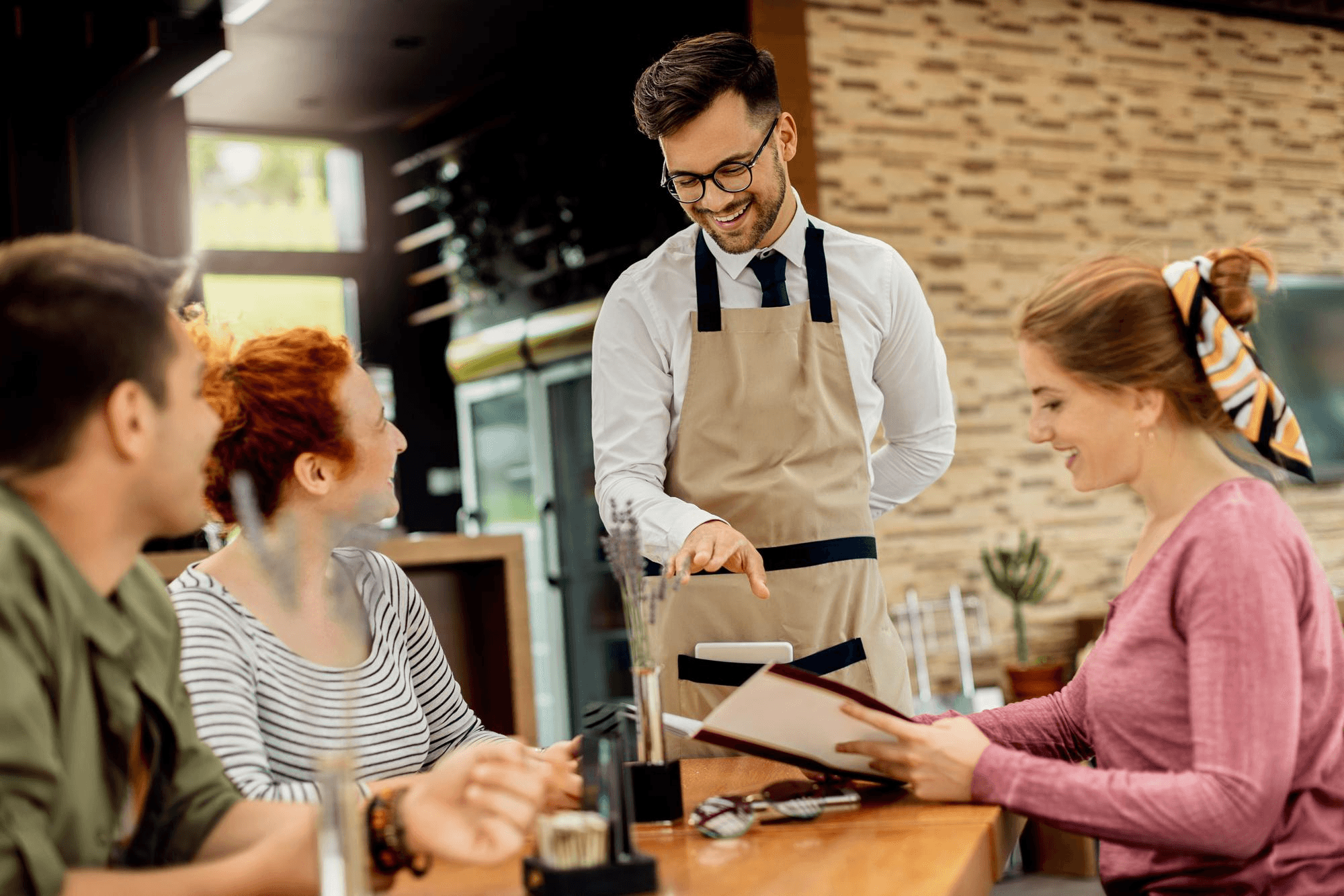Restaurant server assisting customers